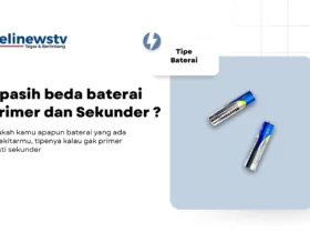 In the center of the image, there is a large, rectangular white box with a blue border. Inside this box, there are two batteries lying on their sides. The batteries are silver with black and blue accents, and they appear to be new or unused. Above the batteries, there is text in Indonesian that reads, "Apa saja baterai Primer dan Sekunder?" This translates to "What are the types of primary and secondary batteries?"